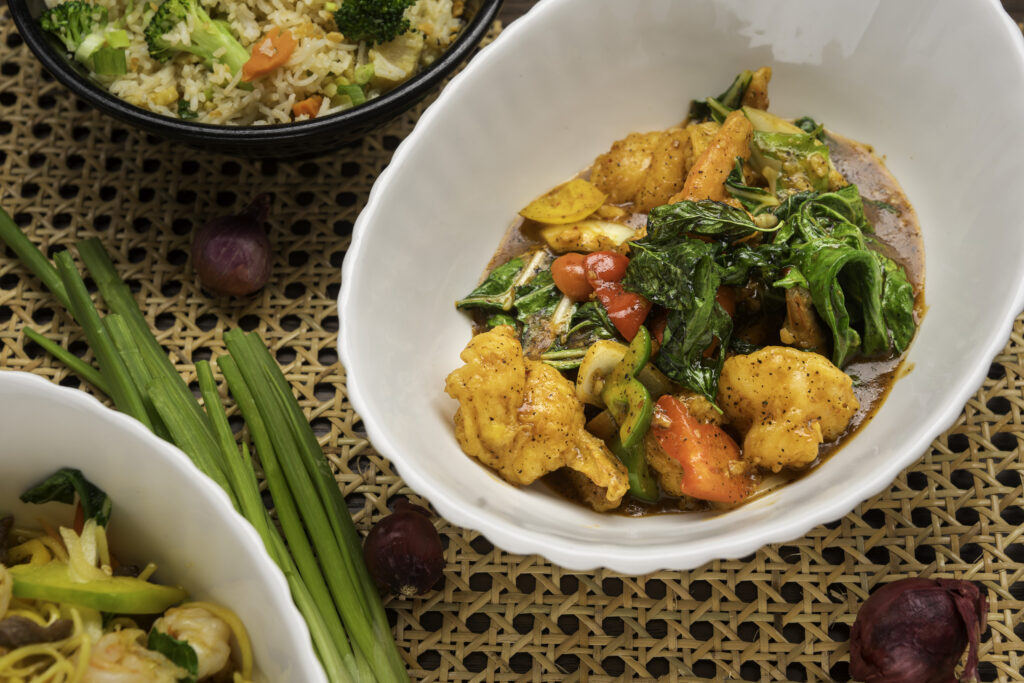 Mystic Thai Jamaica team of chefs and servers smiling in restaurant setting