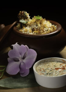 Fragrant Chicken Biryani layered with spiced chicken, basmati rice, and fresh herbs at Mystic Thai Jamaica.
