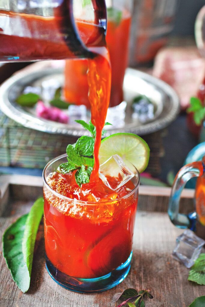 Refreshing Thai iced tea served at Mystic Thai Jamaica with lime and mint garnish