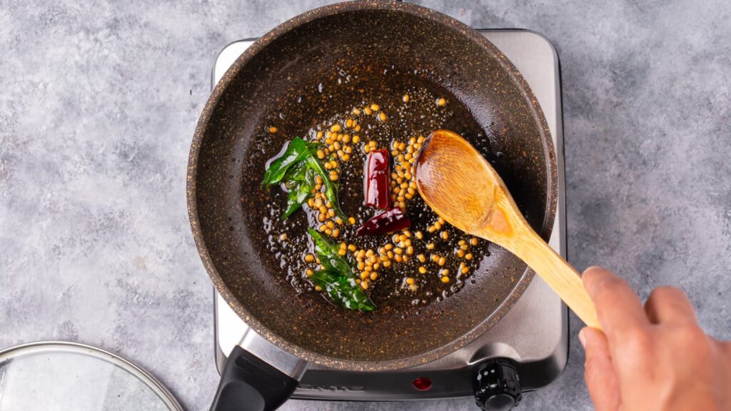 Mystic Thai chef balancing spices in a Thai-Indian curry